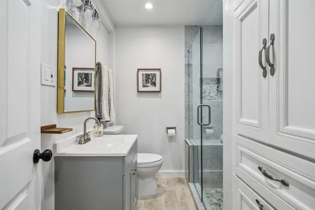 a bathroom with a sink mirror and toilet