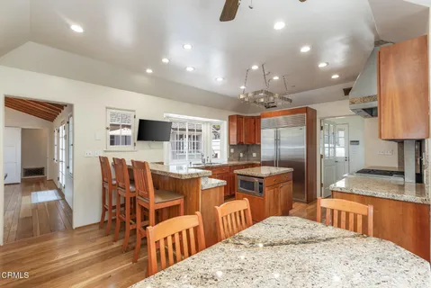 a kitchen with stainless steel appliances kitchen island granite countertop a sink and cabinets