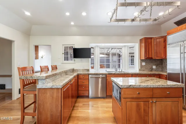 a kitchen with stainless steel appliances granite countertop a sink and a stove