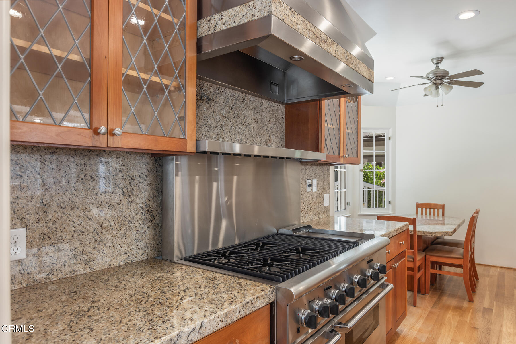 369 West Kenneth Road Glendale, CA 91202 - Photo 18 of 36 a kitchen with granite countertop a stove and a wooden cabinets