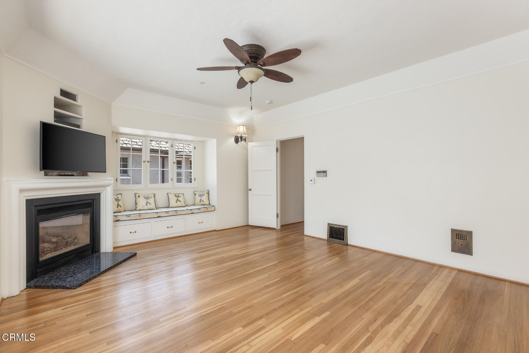 369 West Kenneth Road Glendale, CA 91202 - Photo 21 of 36 a view of a livingroom with a fireplace a ceiling fan and wooden floor