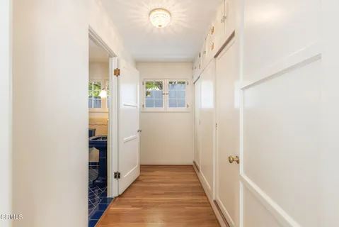 a view of a hallway with wooden floor and staircase