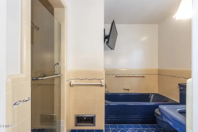 a bathroom with a bathtub and a shower