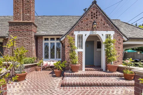 a front view of a house with garden