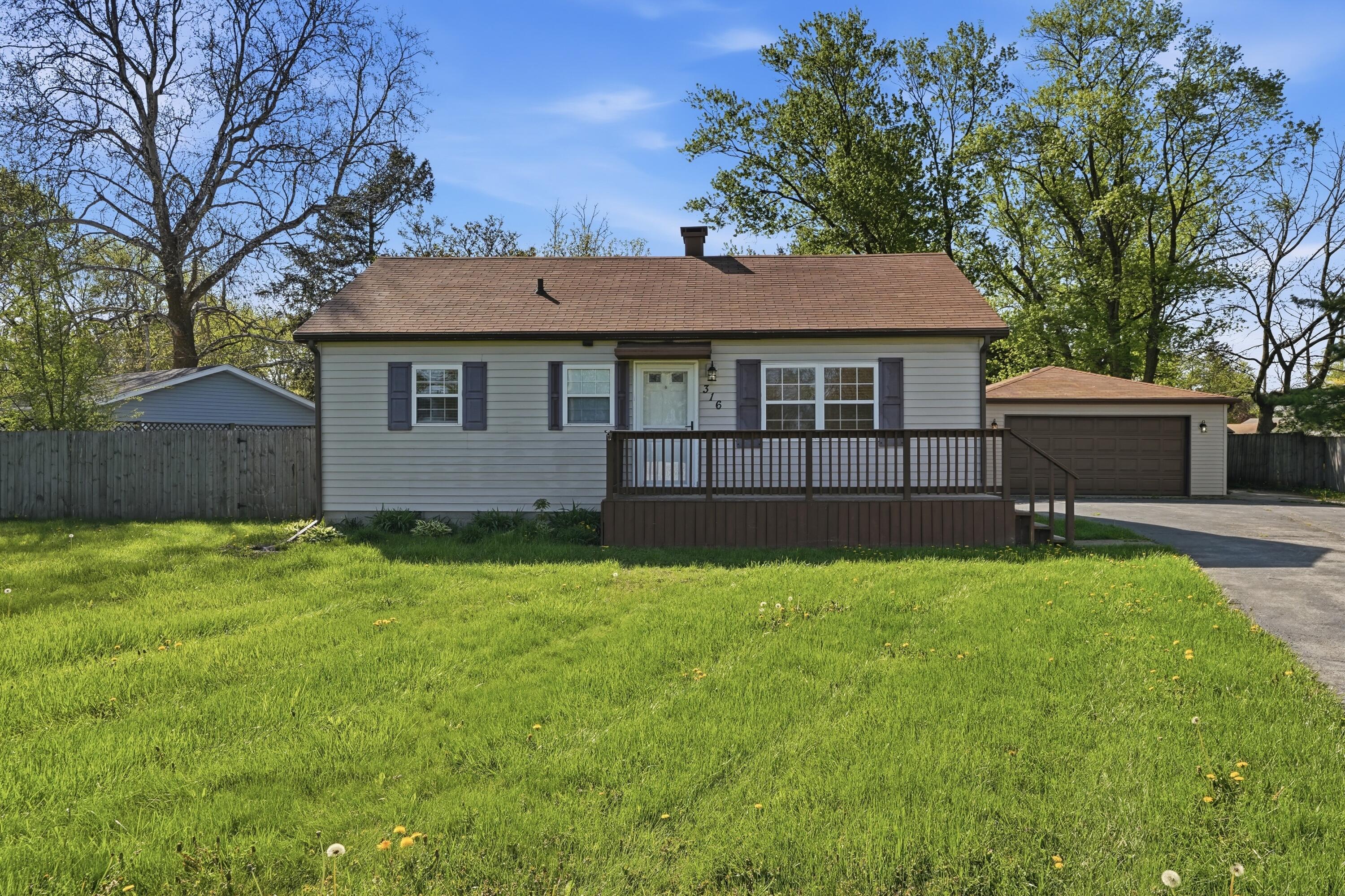 a view of a house with a backyard