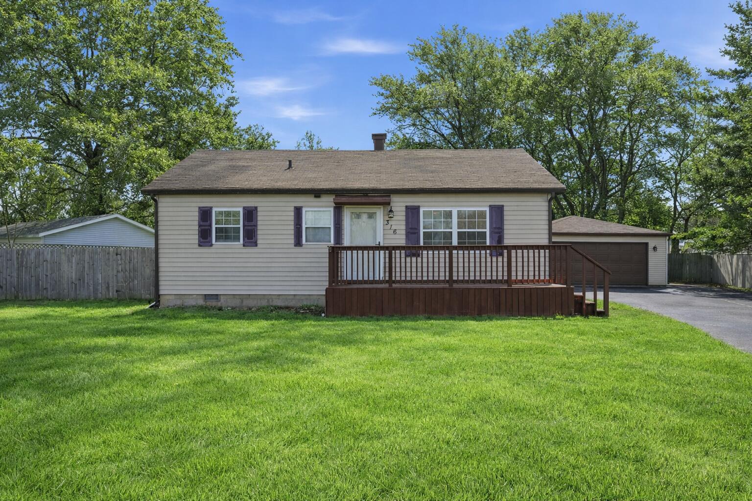 316 Oak Circle Crown Point, IN 46307 - Photo 1 of 19 a view of a house with a yard and a garden