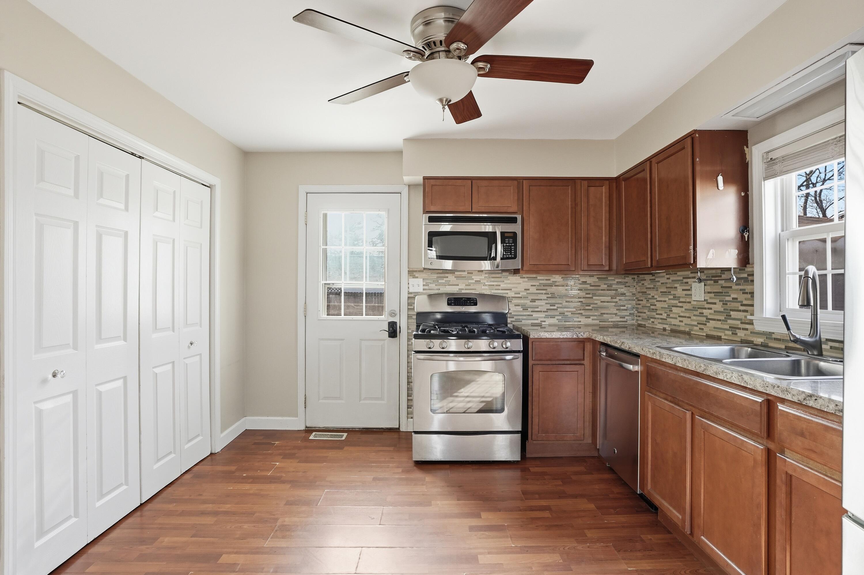 316 Oak Circle Crown Point, IN 46307 - Photo 11 of 19 a kitchen with stainless steel appliances granite countertop a stove sink microwave and refrigerator