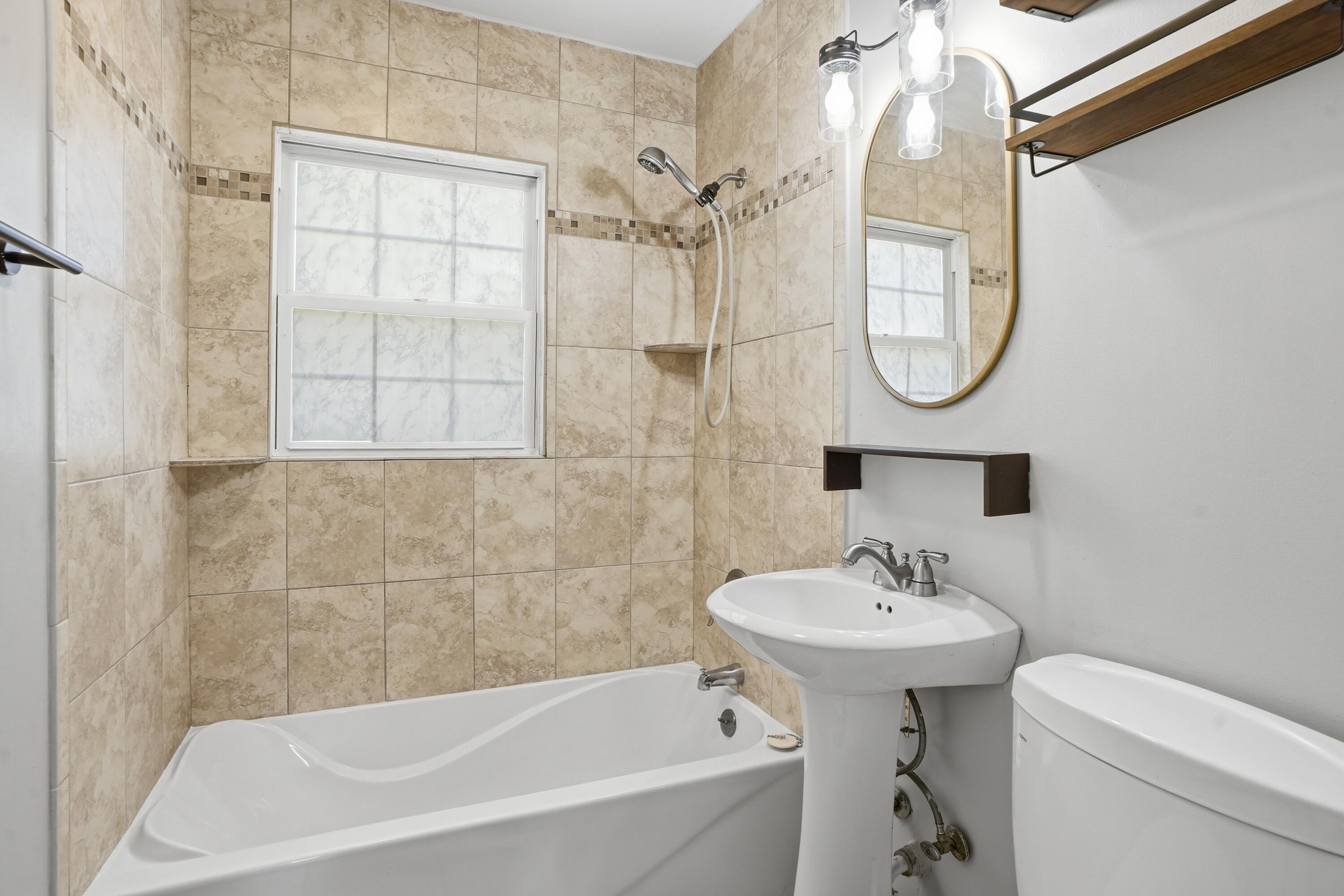 316 Oak Circle Crown Point, IN 46307 - Photo 11 of 19 a bathroom with a sink a mirror and a bathtub