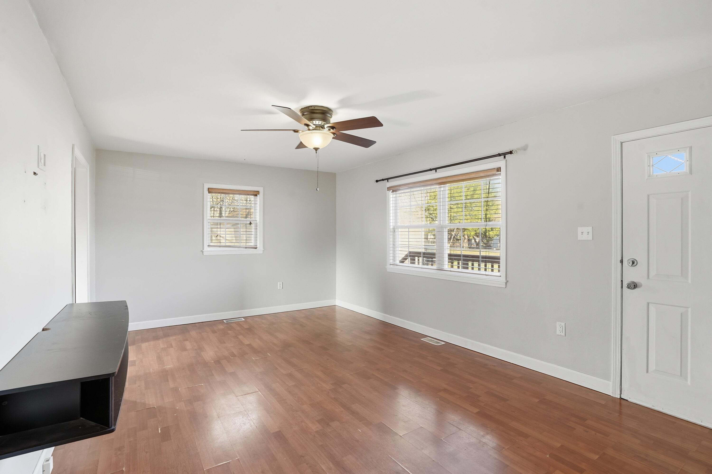 316 Oak Circle Crown Point, IN 46307 - Photo 13 of 19 a view of an empty room with a window and wooden floor