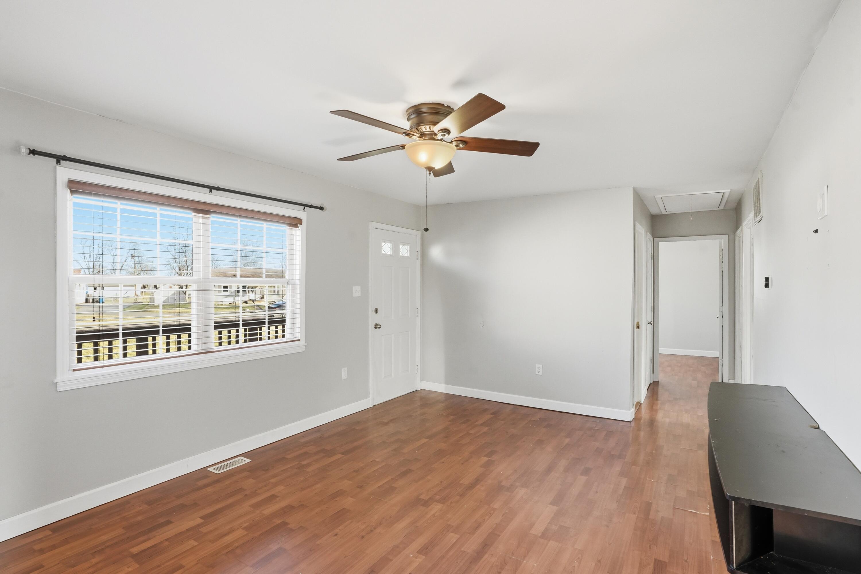 316 Oak Circle Crown Point, IN 46307 - Photo 15 of 19 a view of a livingroom with a window and a ceiling fan