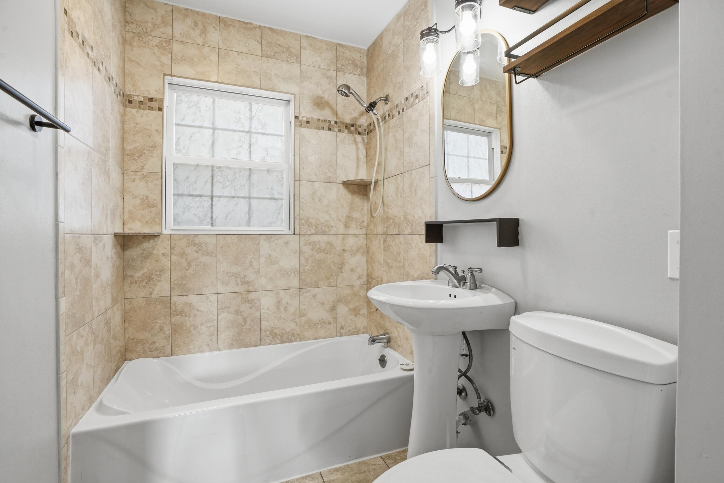 316 Oak Circle Crown Point, IN 46307 - Photo 19 of 19 a bathroom with a sink a toilet and a mirror