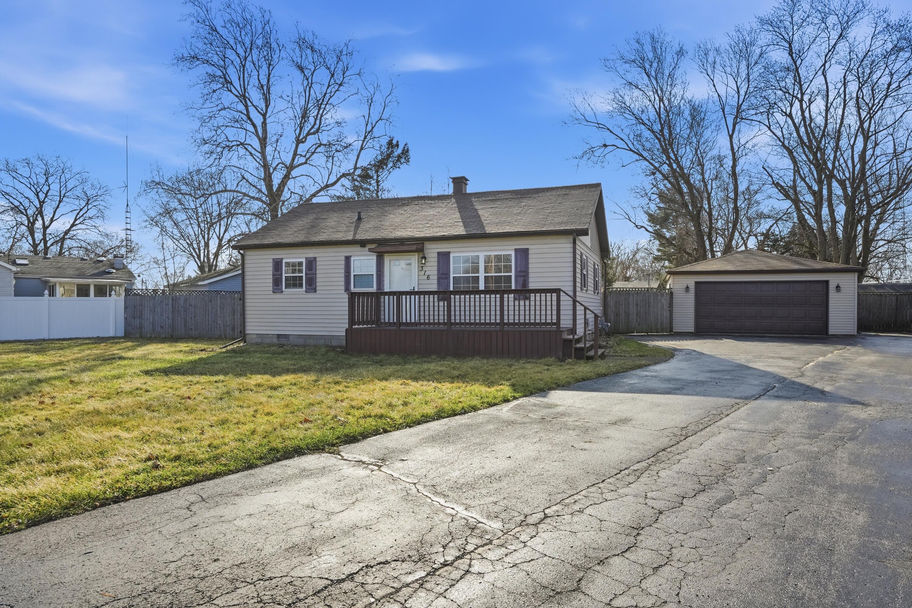 316 Oak Circle Crown Point, IN 46307 - Photo 2 of 19 a front view of a house with a yard and garage