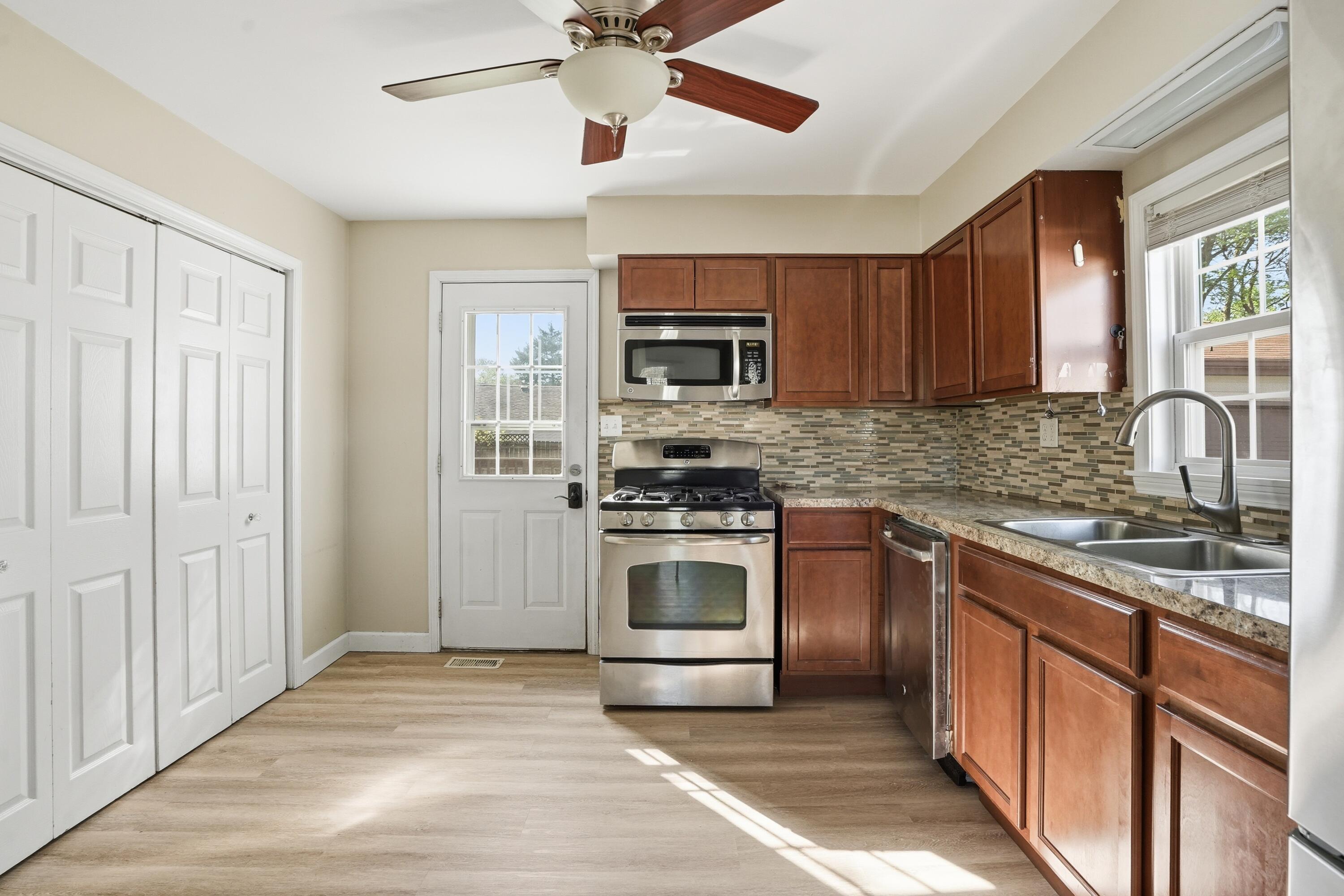 316 Oak Circle Crown Point, IN 46307 - Photo 3 of 19 a kitchen with stainless steel appliances granite countertop a stove sink microwave and refrigerator