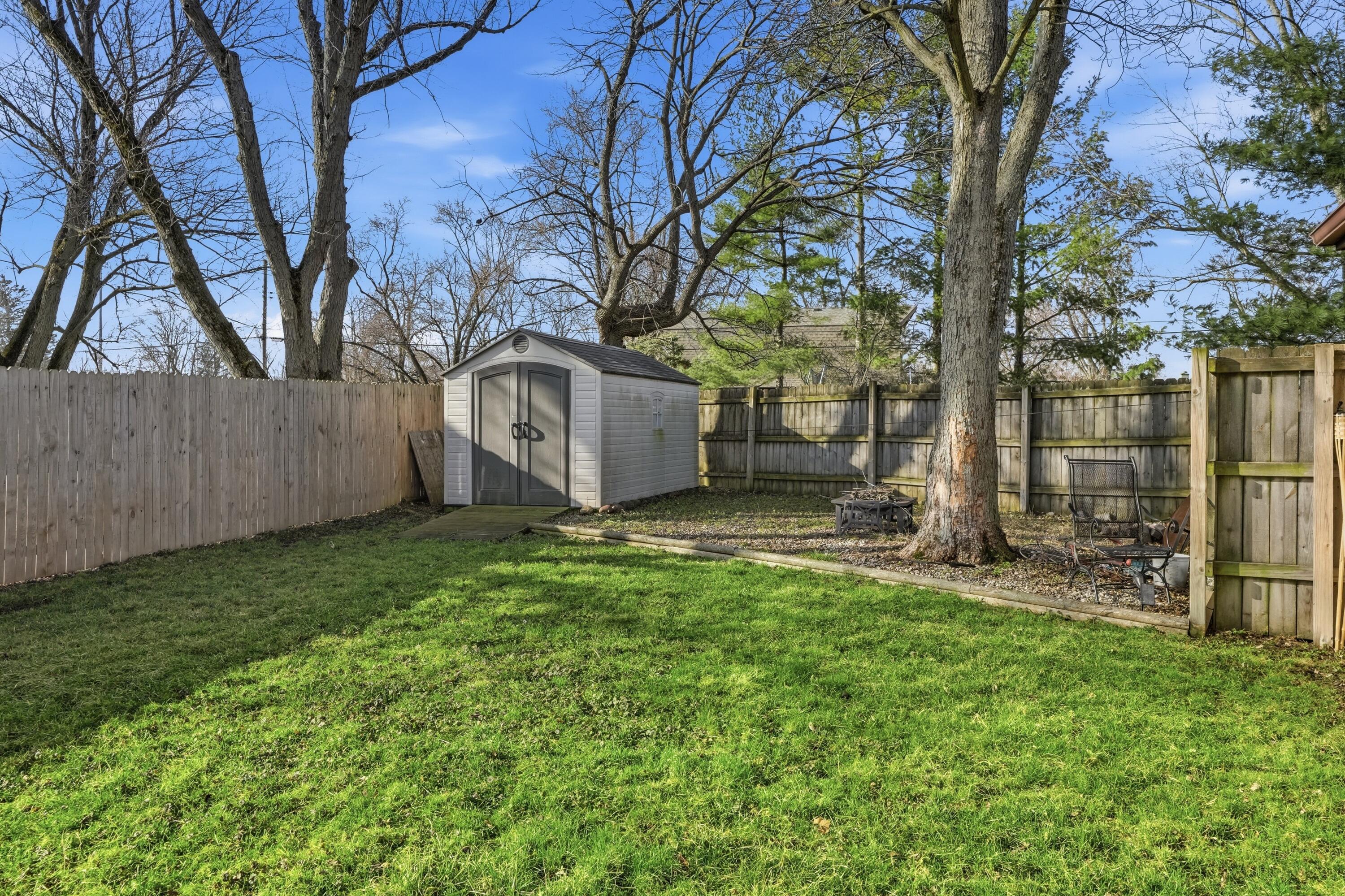 316 Oak Circle Crown Point, IN 46307 - Photo 6 of 19 a view of a backyard with large tree