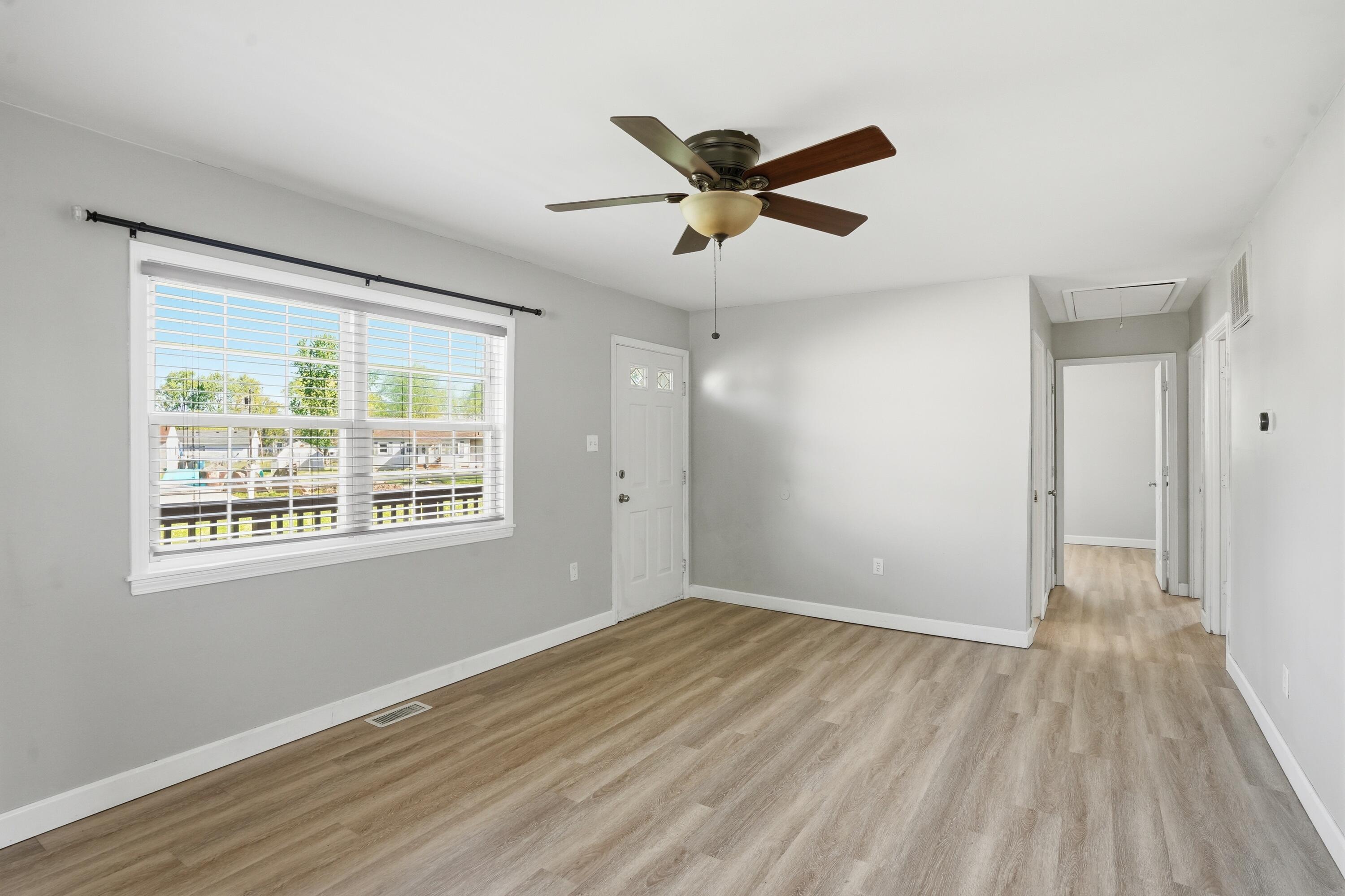 316 Oak Circle Crown Point, IN 46307 - Photo 6 of 19 a view of a big room with wooden floor and windows