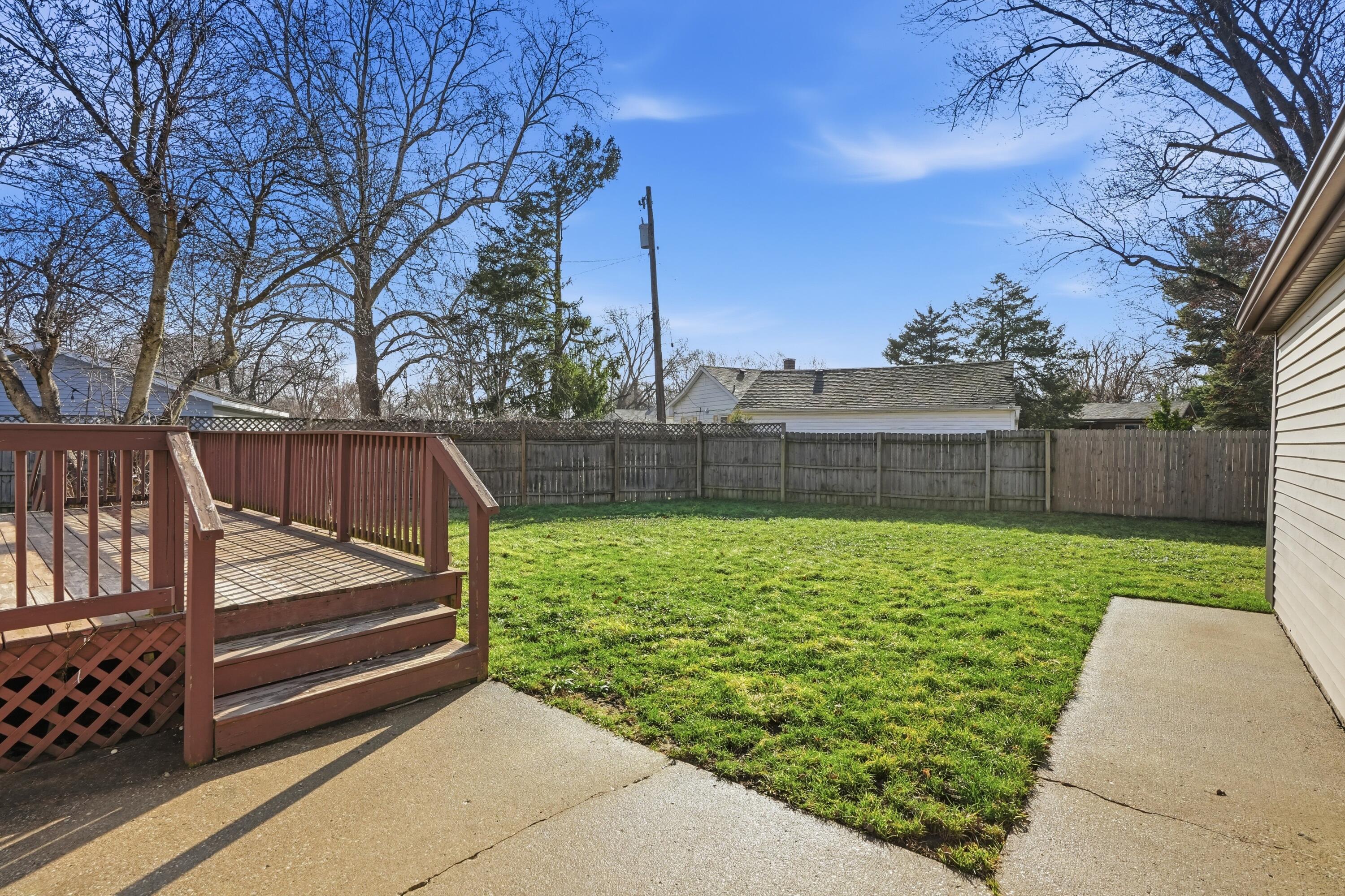 316 Oak Circle Crown Point, IN 46307 - Photo 7 of 19 a view of backyard with wooden fence and large trees