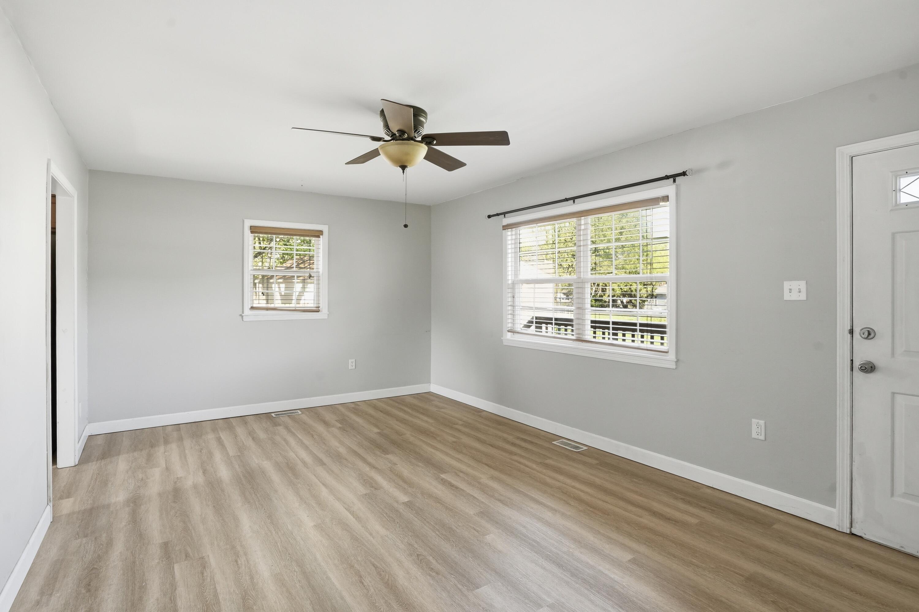 316 Oak Circle Crown Point, IN 46307 - Photo 7 of 19 a view of empty room with wooden floor and fan