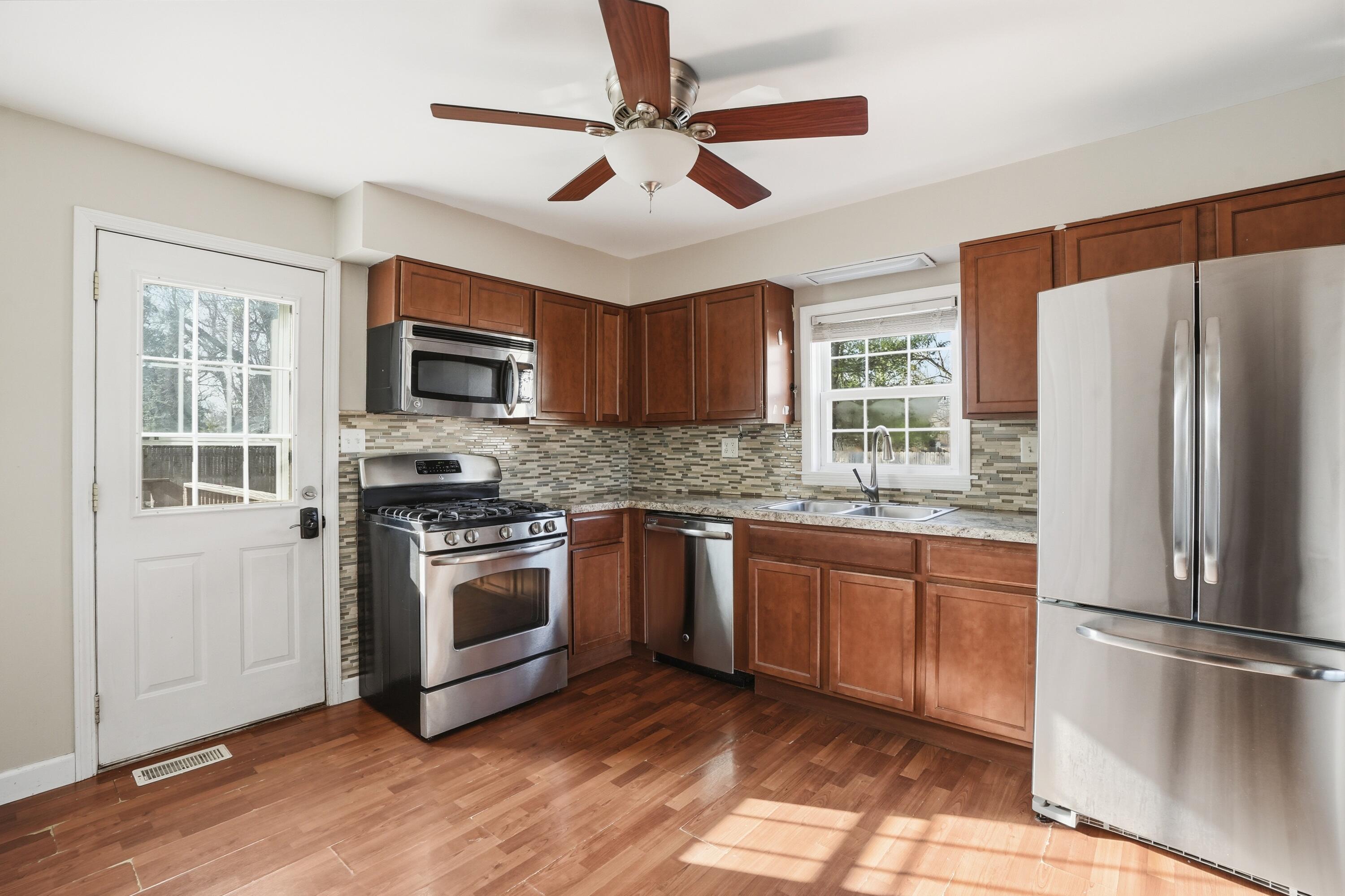 316 Oak Circle Crown Point, IN 46307 - Photo 10 of 19 a kitchen with stainless steel appliances granite countertop a refrigerator a stove a sink and a microwave