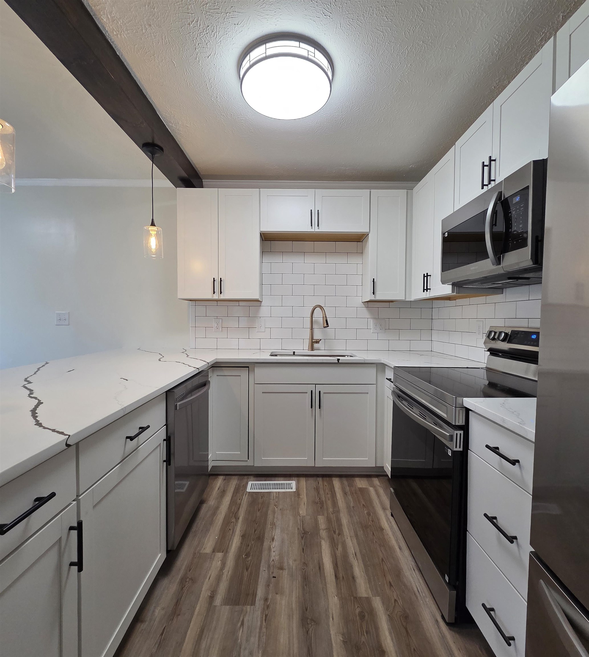 230 Dodge Street Stuarts Draft, VA 24477 - Photo 4 of 14 a kitchen with a sink stove and microwave