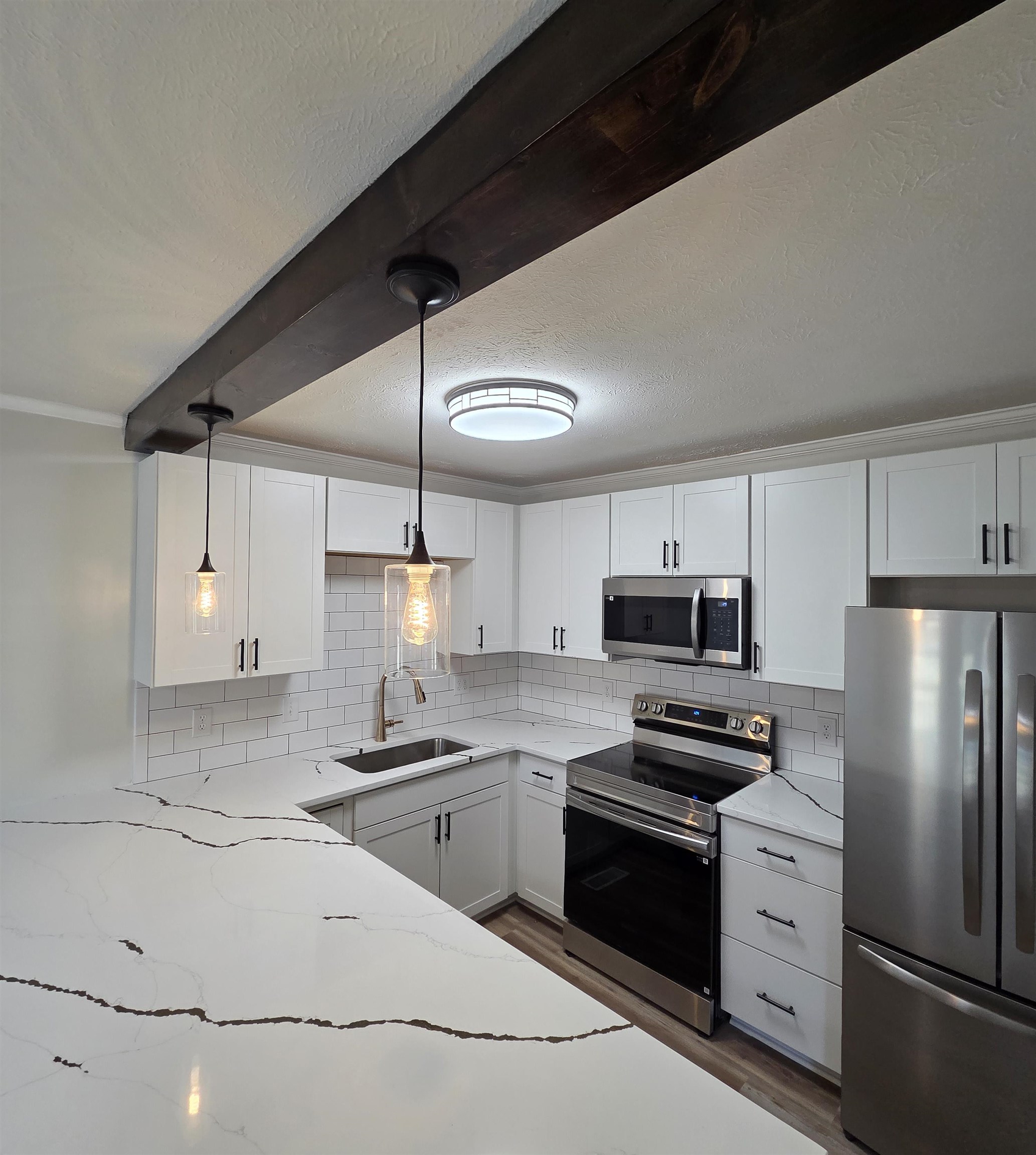 230 Dodge Street Stuarts Draft, VA 24477 - Photo 5 of 14 a kitchen with stainless steel appliances a refrigerator sink and white cabinets