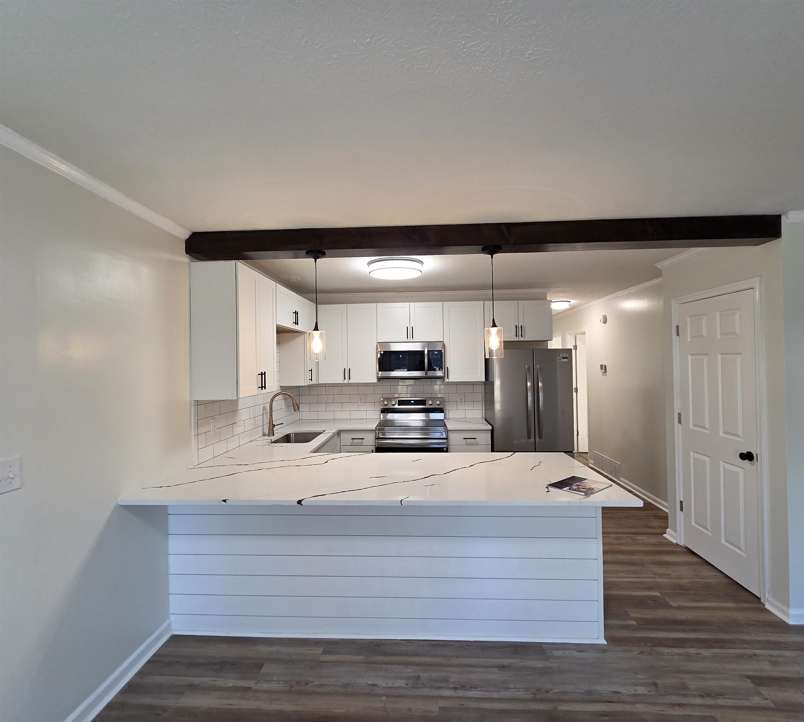 230 Dodge Street Stuarts Draft, VA 24477 - Photo 7 of 14 a large white kitchen with wooden floors and a fireplace