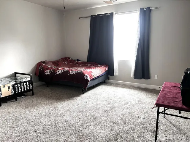 a bedroom with a bed and a chair