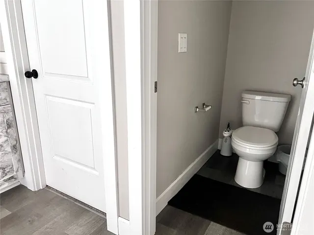a bathroom with a toilet and a mirror