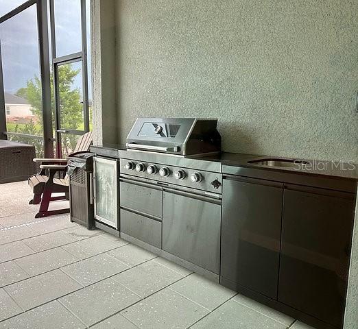 17577 Santorini Court Venice, FL 34293 - Photo 21 of 54 a kitchen with a stove and a microwave