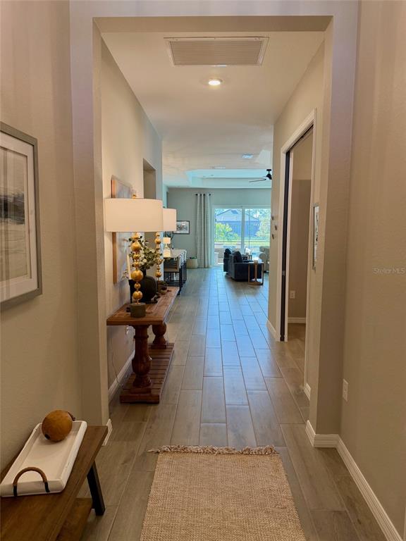 17577 Santorini Court Venice, FL 34293 - Photo 5 of 54 a living room with furniture and a chandelier