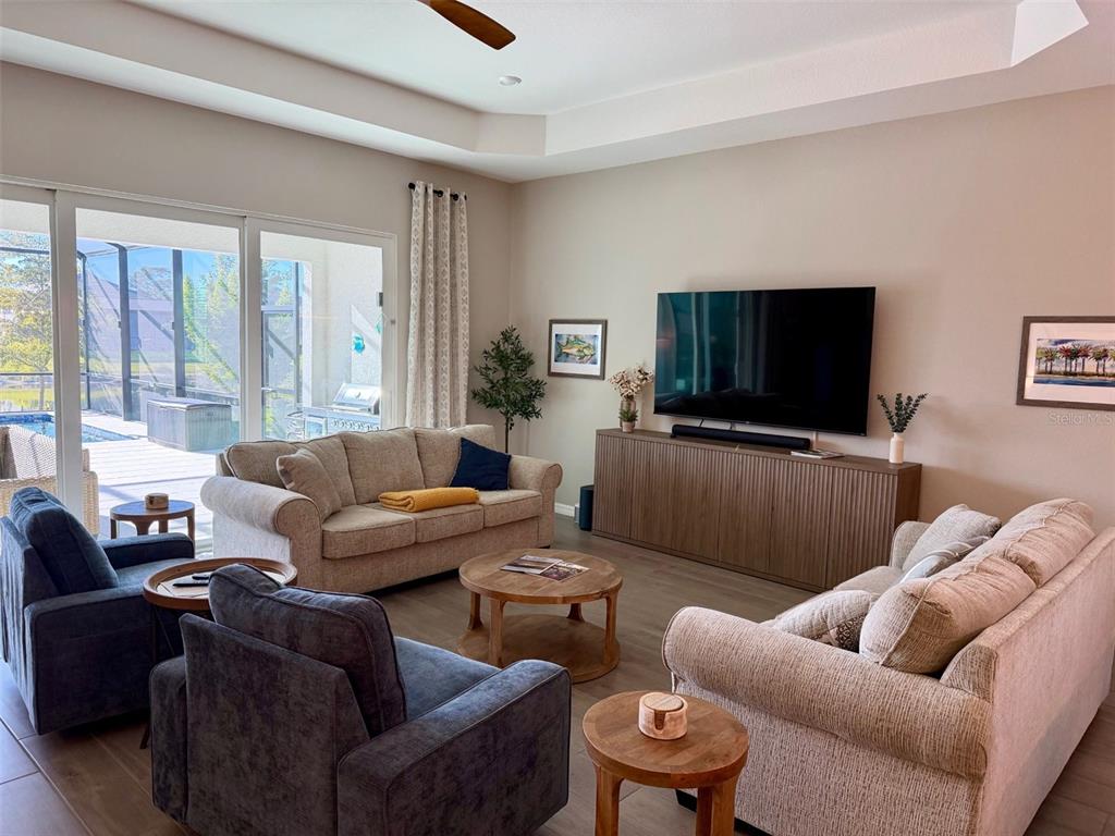 17577 Santorini Court Venice, FL 34293 - Photo 9 of 54 a living room with furniture and a flat screen tv