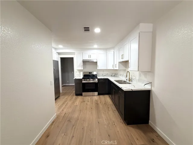 a kitchen with a sink and cabinets