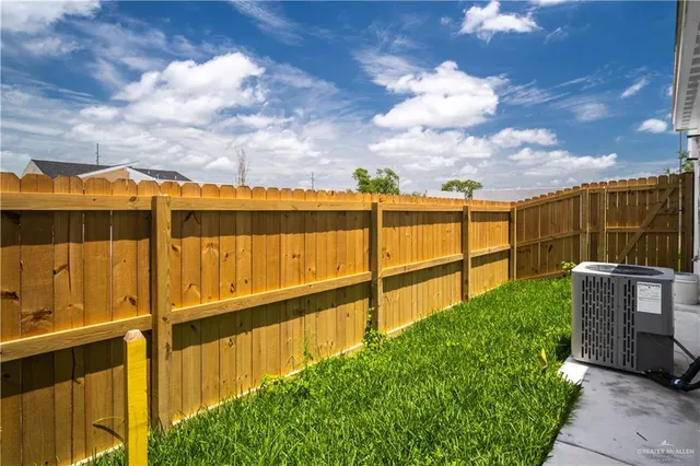a view of a pathway with a wrought fence