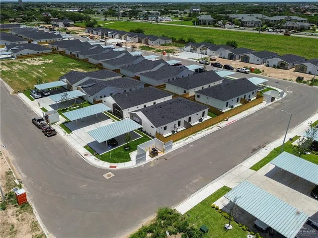 an aerial view of a house with a garden and lake view