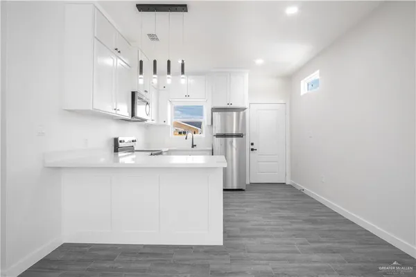 a view of kitchen with wooden floor