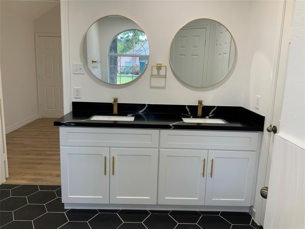 206 Doncaster Conroe, TX 77303 - Photo 13 of 28 a bathroom with a sink a vanity and a mirror