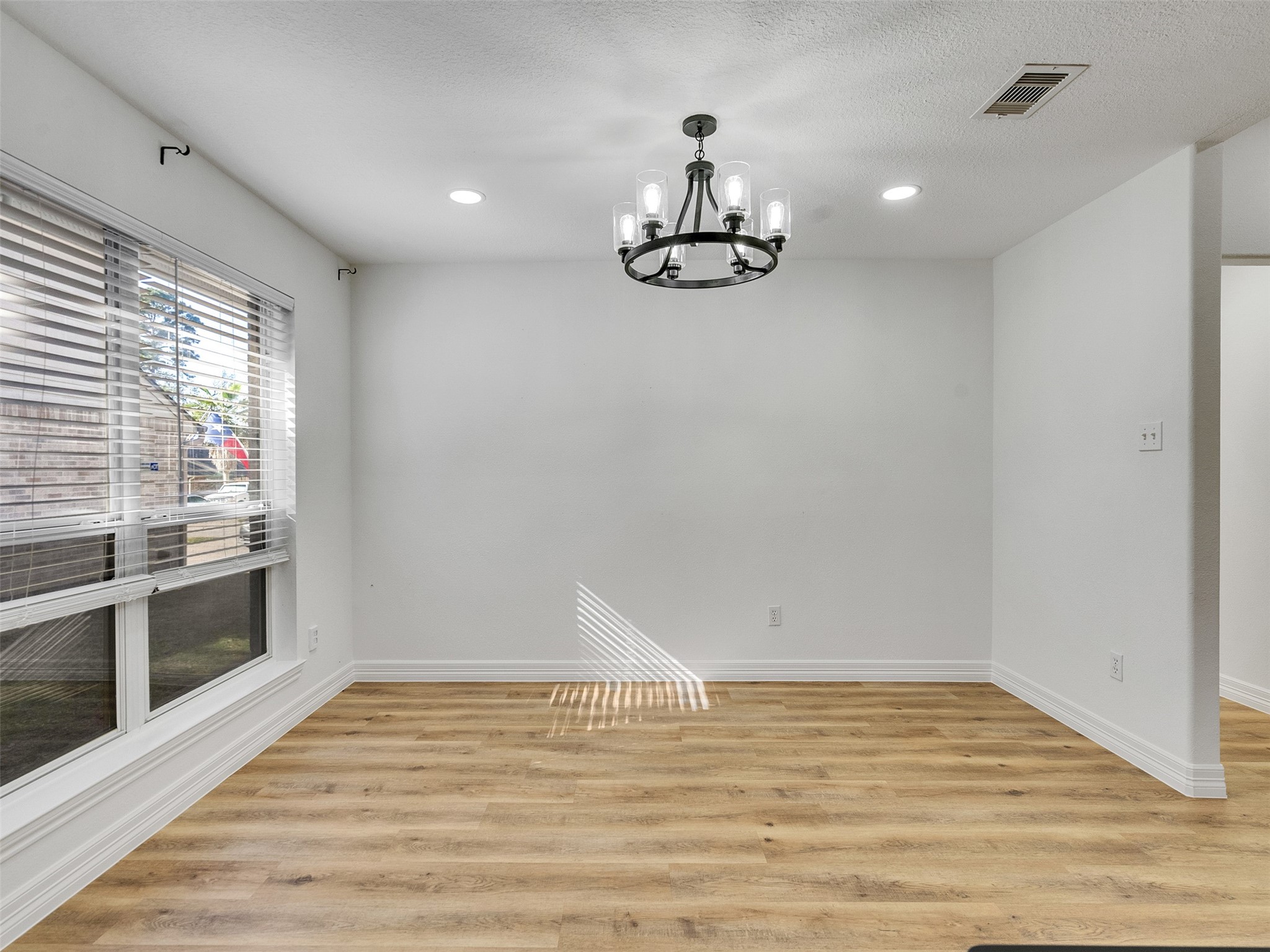206 Doncaster Conroe, TX 77303 - Photo 14 of 38 a view of empty room with wooden floor