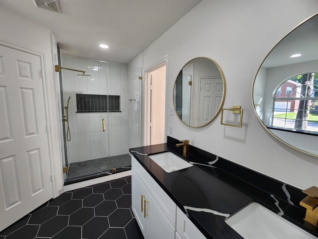206 Doncaster Conroe, TX 77303 - Photo 15 of 28 a bathroom with a double vanity sink and a mirror