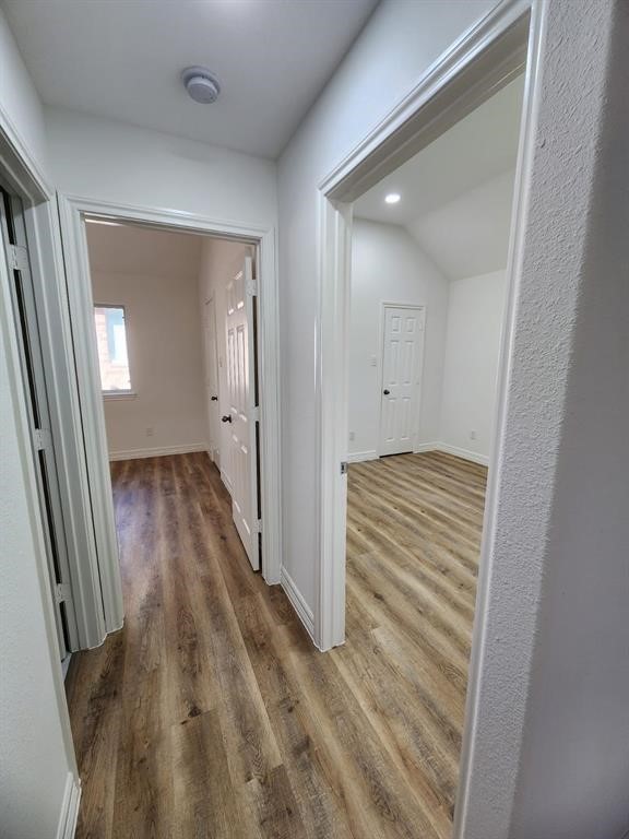 206 Doncaster Conroe, TX 77303 - Photo 17 of 28 a view of a hallway with wooden floor and a bathroom