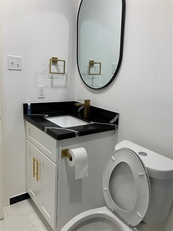 206 Doncaster Conroe, TX 77303 - Photo 24 of 28 a bathroom with a toilet and a mirror