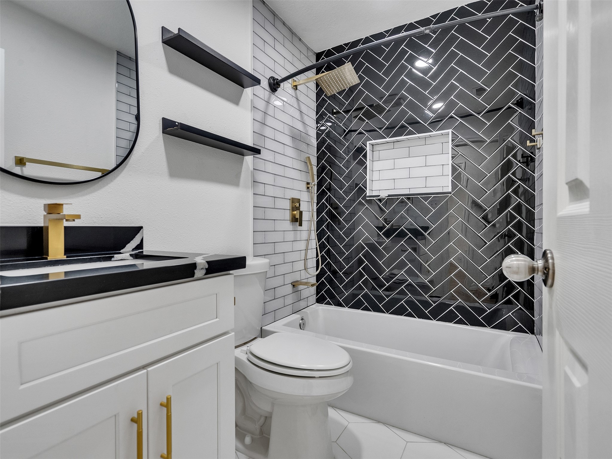 206 Doncaster Conroe, TX 77303 - Photo 25 of 38 a bathroom with a toilet a sink and bathtub