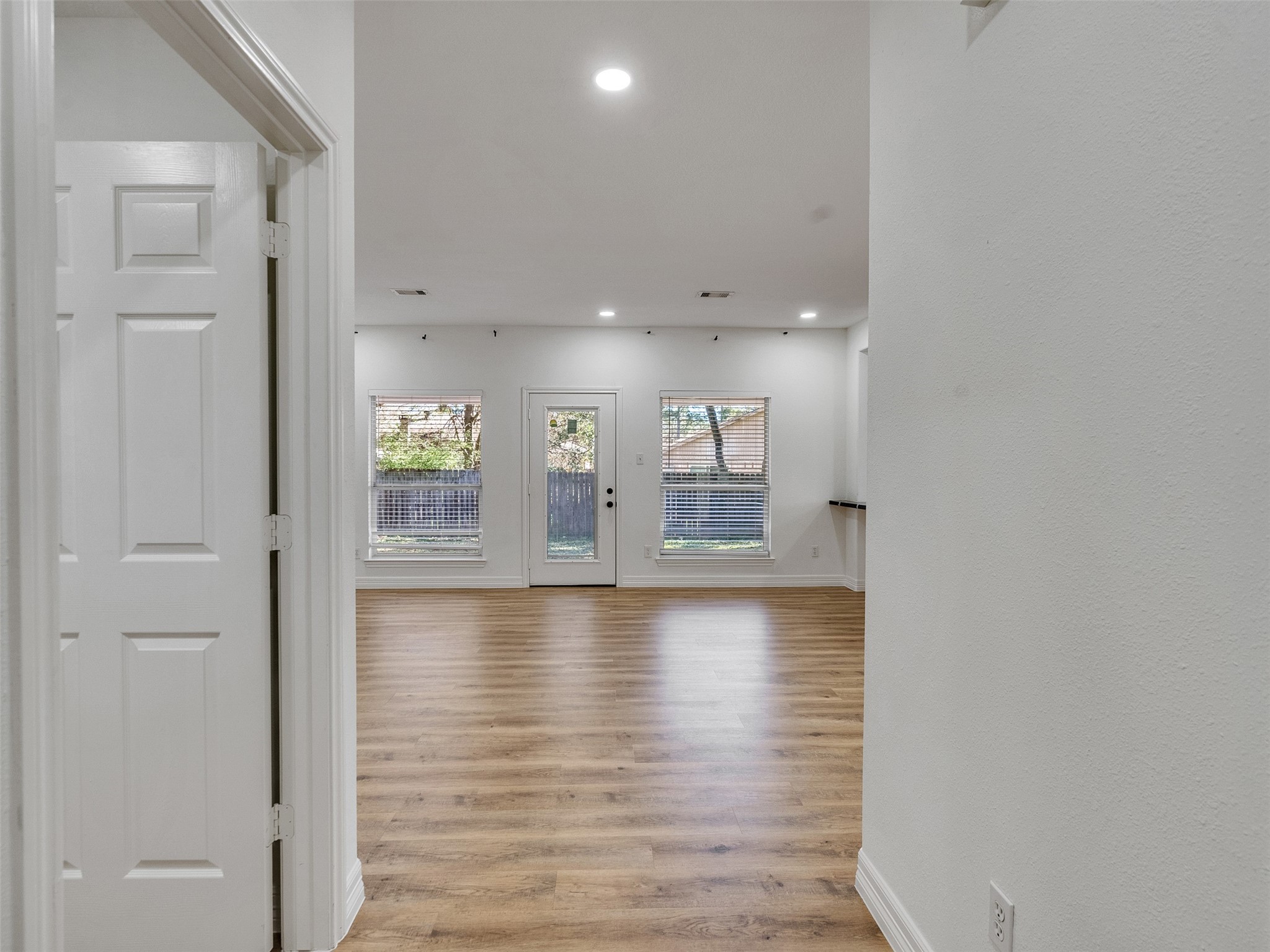 206 Doncaster Conroe, TX 77303 - Photo 3 of 38 a view of empty room with wooden floor and windows
