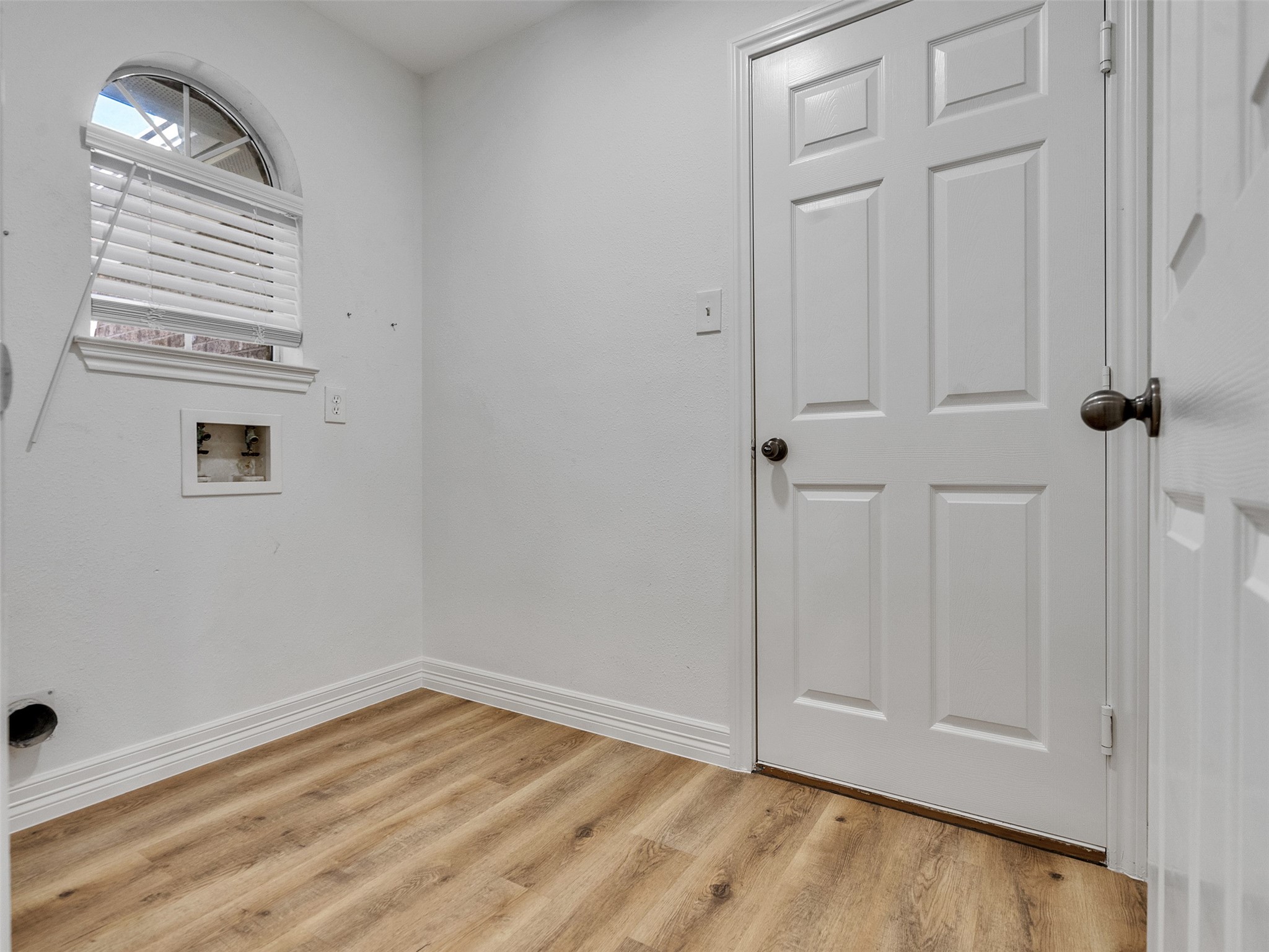 206 Doncaster Conroe, TX 77303 - Photo 4 of 38 a view of an empty room with wooden floor and a window