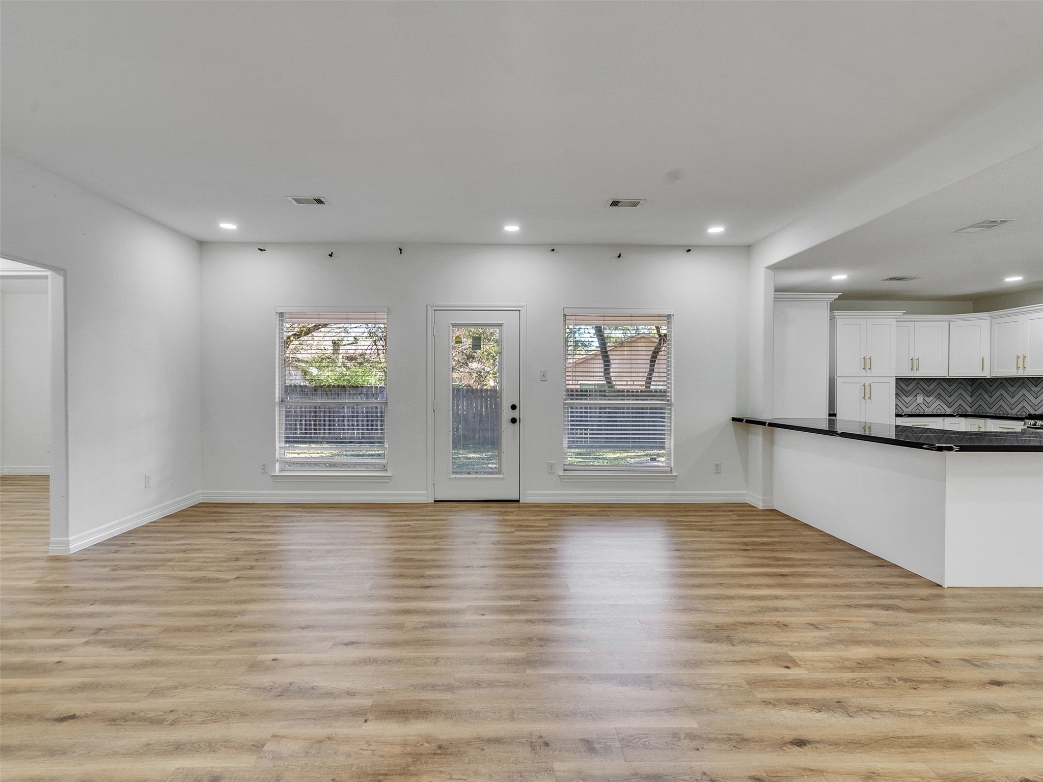 206 Doncaster Conroe, TX 77303 - Photo 5 of 38 a view of an empty room with a window and wooden floor