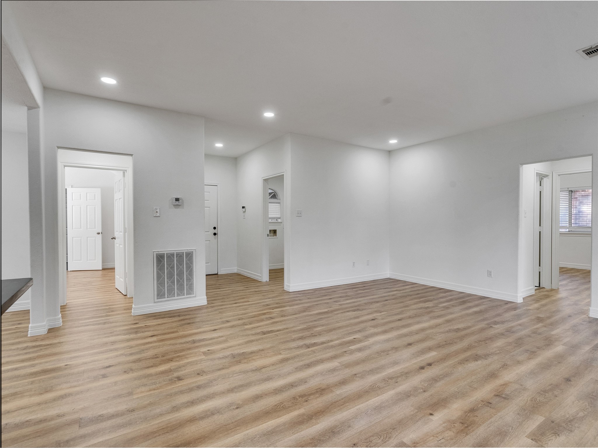206 Doncaster Conroe, TX 77303 - Photo 8 of 38 a view of an empty room with wooden floor