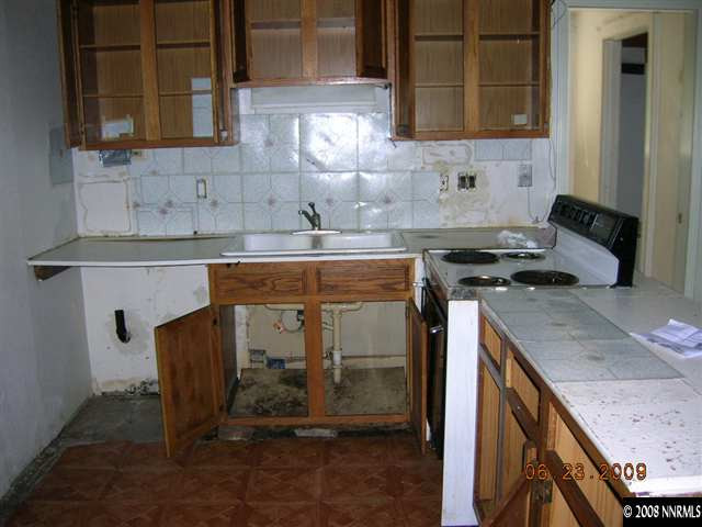 17900 South Virginia Street Reno, NV 89521 - Photo 4 of 9 a kitchen with a sink cabinets and a wooden floor