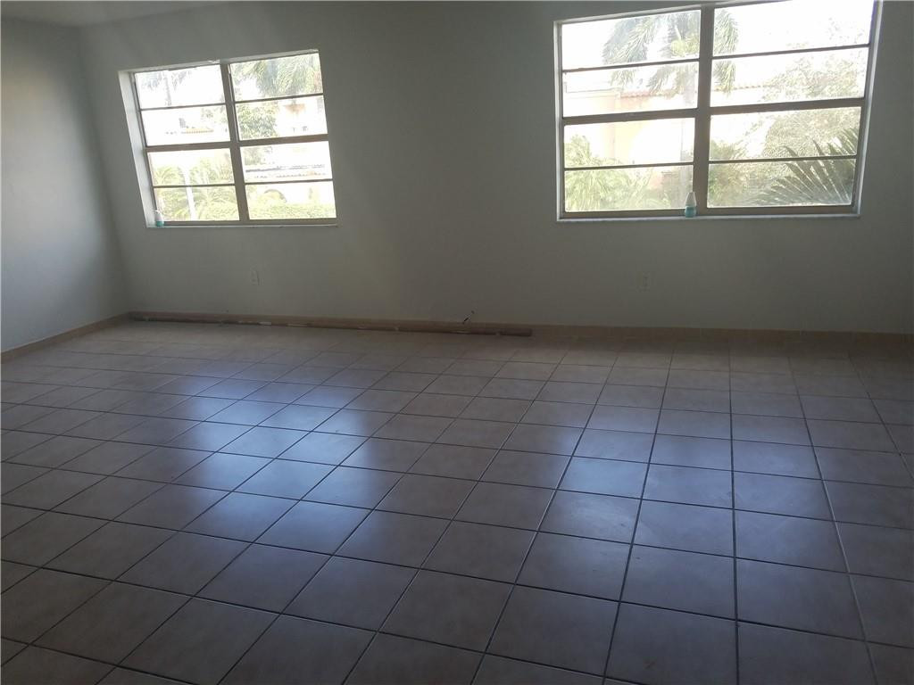 1300 West 53rd Street, Unit 7 Hialeah, FL 33012 - Photo 14 of 22 an empty room with a window