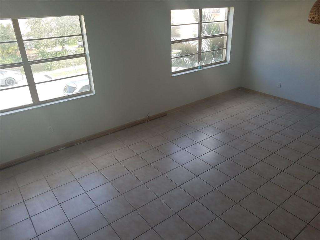 1300 West 53rd Street, Unit 7 Hialeah, FL 33012 - Photo 15 of 22 an empty room with windows
