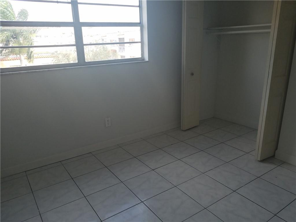 1300 West 53rd Street, Unit 7 Hialeah, FL 33012 - Photo 17 of 22 an empty room with a window