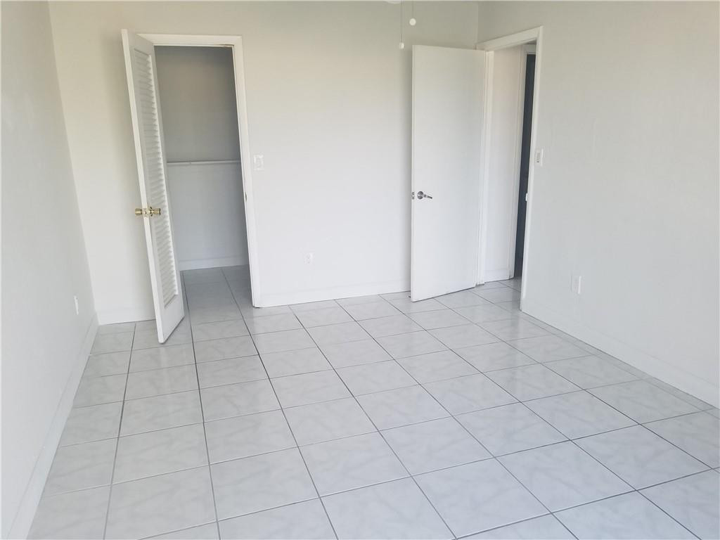 1300 West 53rd Street, Unit 7 Hialeah, FL 33012 - Photo 18 of 22 an empty room with white door
