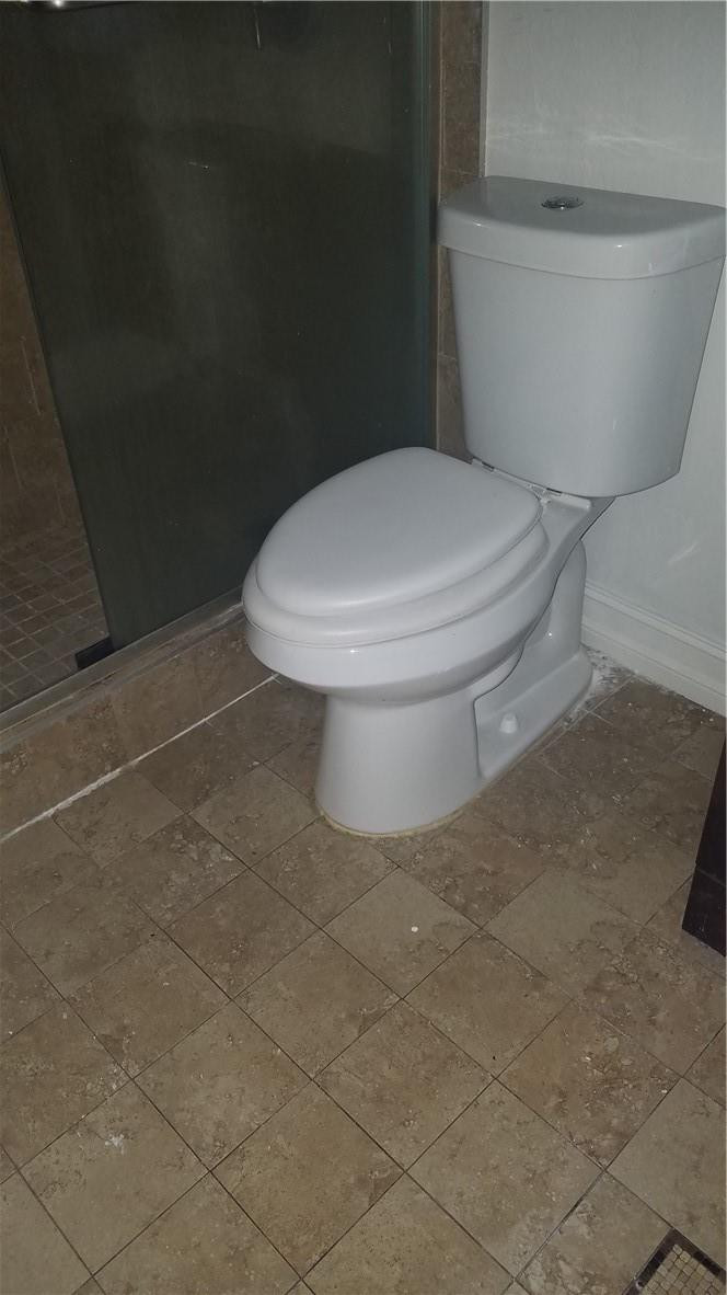 1300 West 53rd Street, Unit 7 Hialeah, FL 33012 - Photo 19 of 22 a white toilet sitting next to a shower